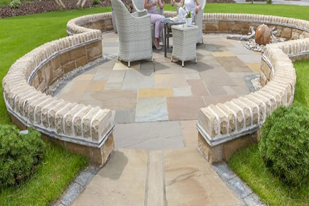 image of a Pathway being laid mid job, on the image we see the Breathable membrane, then the Charcoal Block Paving that we used as Edging stone or Border, then the Buff flagstones that compliment the whole look and feel of the design, this works our really well and looks striking but traditionally homely